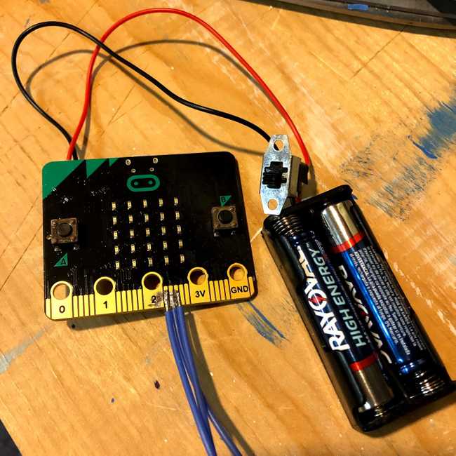 image of a micro:bit with wires soldered to it.